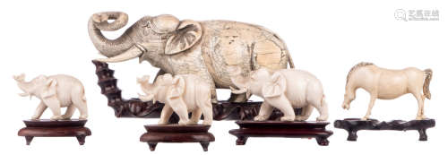 A Chinese carved mammoth ivory elephant, on a matching wooden stand; added four Chinese ivory sculptures depicting elephants and a horse, first half of the 20thC, on matching wooden stands, H 5,5 - 10,5 (without stand) - 8 - 14,5 cm (with stand) - Weight: about 119 - 125 - 142 - 239 and 1637g (with stand)