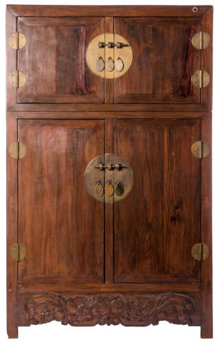A Chinese carved wooden cabinet, the doors with a circular brass mount, H 176 - W 109 - D 51,5 cm