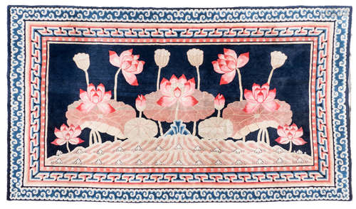 A fine Chinese rug, depicting lotus flowers, with a meandering frieze, wool on cotton, 196 x 345 cm