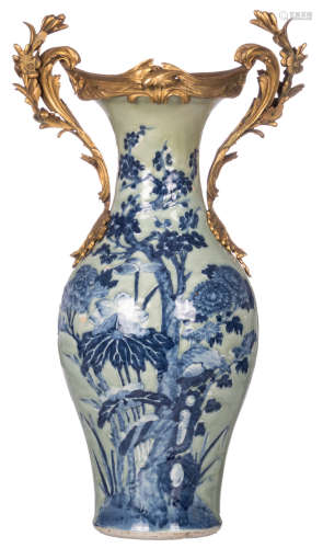 A Chinese celadon baluster shaped vase, blue and white decorated with flower branches and a butterfly, with a gilt bronze mount, 19thC, H 70 cm