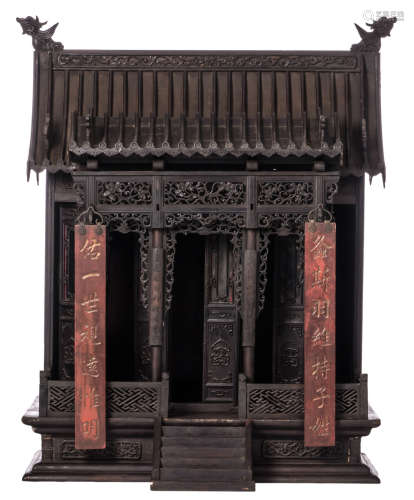 A Chinese wooden domestic shrine, carved and ajour decorated, in front two hanging panels with calligraphic texts, H 121,5 - W 102,5 - D 70,5 cm