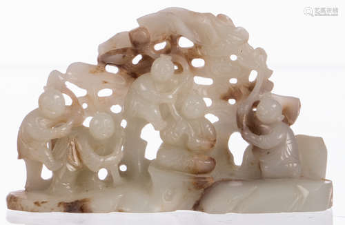 A Chinese jade carved group, depicting five boys playing in a garden, Qing dynasty, H 7 - W 12 cm