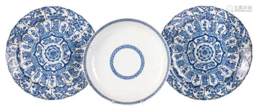 Two Chinese blue and white floral decorated plates, marked Kangxi, ø 30,5 cm; added a Chinese blue and white floral relief decorated plate, marked, 18thC, ø 27,5 cm