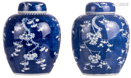 A pair of Chinese blue ground ginger jars and covers, decorated with prunus blossoms, H 29 cm