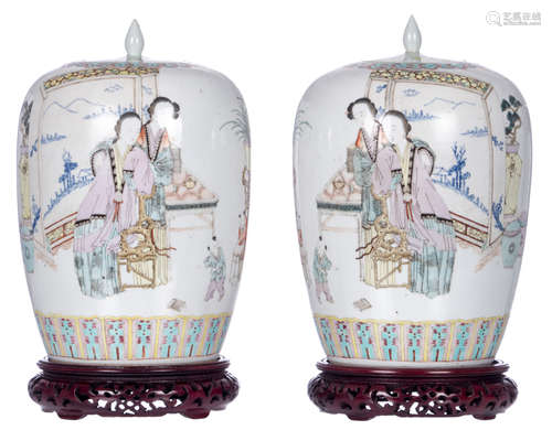 A pair of Chinese polychrome ginger jars and covers, decorated with two ladies and two children and calligraphic texts, marked, 19thC, on a matching wooden stand, H 33 (without stand) - 36,5 cm (with stand)