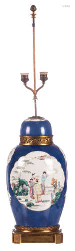 A Chinese blue poudré ground jar and cover, the roundels famille rose, decorated with animated scenes, antiquities and flower branches, Kangxi marked, 19thC, mounted as a lamp, H 45 cm