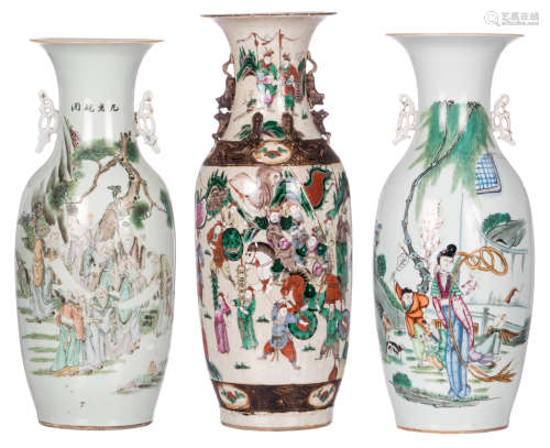 Two Chinese polychrome decorated vases, one with an animated garden scene and one with literati, with calligraphic texts, H 58 cm; added a Chinese stoneware vase, overall decorated with warriors, marked, about 1900, H 60 cm