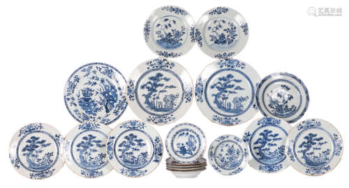 Seventeen Chinese blue and white floral decorated dishes with flower branches, trees and rocks, 18thC, ø 16 - 27,5 cm