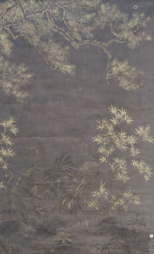 A Chinese textile painting, the paint with ink and powder gilt, depicting cranes, bamboo and a pine, signed, late Qing period, 85 x 139 cm