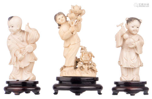 Two Chinese carved ivory figures depicting young musicians, first half of the 20thC, on a matching wooden stand; added a ditto sculpture depicting a girl with flower branches, H 11 - 11,5 (without stand) - 13 - 15 cm (with stand) - Weight: about 160 - 172 - 230g