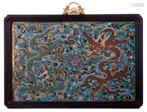 A fine Chinese cloisonné and enamel plaque, depicting dragons in a cloudy sky playing with the flaming pearl, in a wooden frame, 42 x 62 cm