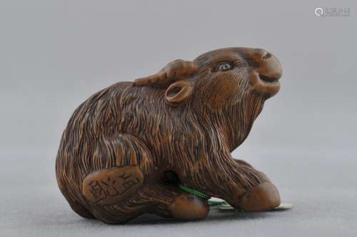 Carved wooden Netsuke of a ram with inlaid eyes. Signed