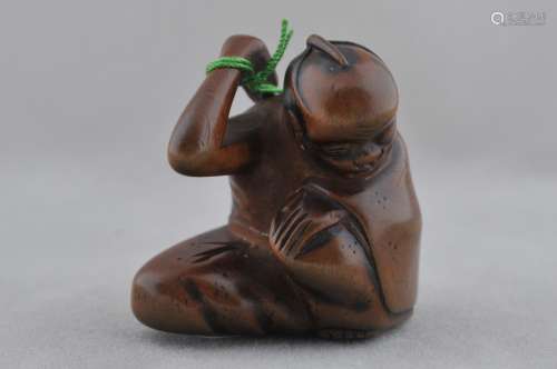 Carved wooden Netsuke. Japan. 19th century. Seated man