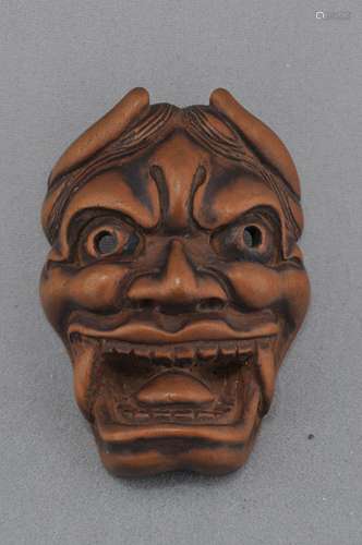 Carved wooden Netsuke. Japan. 19th century. Oni mask.