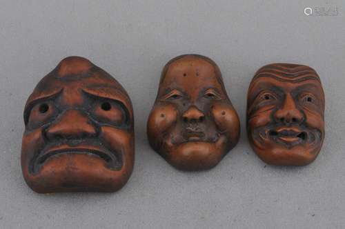 Lot of three wooden mask Netsuke. Japan. 19th century.