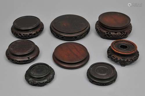 Lot of eight carved hardwood stands. China. 19th