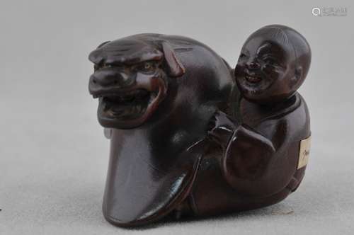 Carved wooden Netsuke. Japan. 19th c. Child with mask.