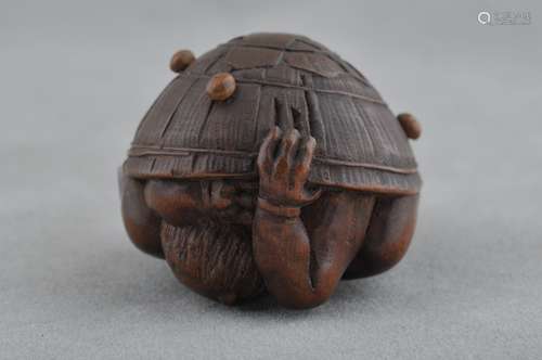 Carved wooden Netsuke. Japan. 19th century. Oni hiding