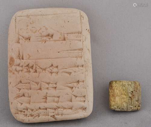 Two Cuniform Clay tablets. One reading 