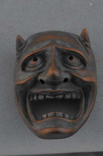 Carved wooden Netsuke. Japan. 19th century. Mask of an