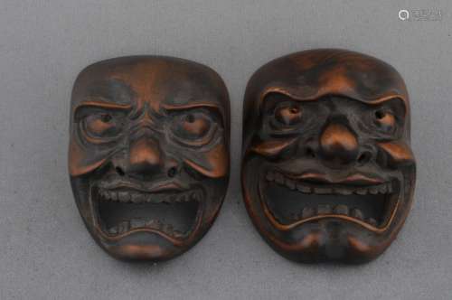 Lot of two wooden mask Netsukes. Japan. 19th century.
