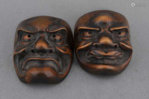 Lot of two wooden mask Netsukes. Japan. 19th century.