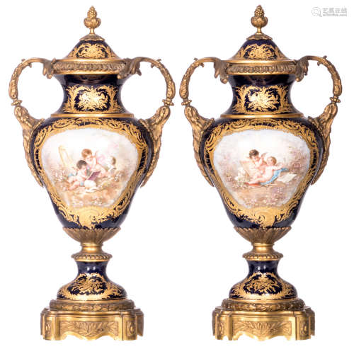 A pair of ornamental vases with gold-layered bleu royal ground, decorated with art-loving putti and views on a ruin, signed Poitevin, gilt bronze mounts, with a blue overglaze Sèvres mark, 19thC, H 61 cm