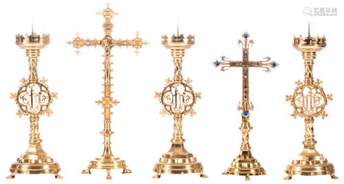 Three Gothic Revival brass candlesticks and two ditto crucifixes, one with a relic, H 59 - 68,5 cm