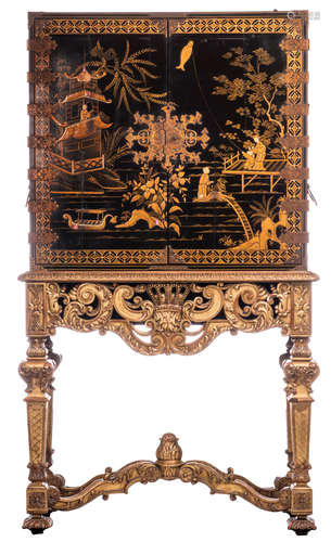 A Chinoiserie lacquered cabinet on a richly carved gilt wooden stand,  H 196 - W 113 cm