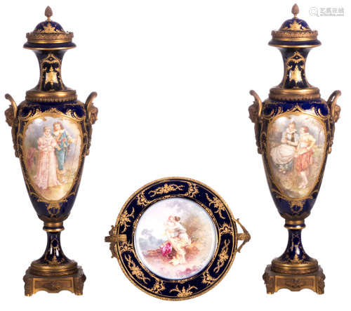 A pair of bleu royal ground vases, gilt bronze mounts, the roundels decorated with gallant scenes, with a Sèvres mark, H 60 cm; added a ditto platter depicting Venus and Cupid, with a Sèvres mark, H 14 - B 25 cm