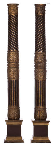 Two patinated gilt wood columns, 17thC, both mounted on a base of a later date, H 180 (without base) - 213 cm (with base)