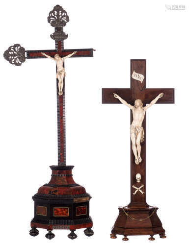 A rosewood crucifix with an 18thC ivory corpus; added a crucifix, late 17thC, set with tortoise, ivory and ebony, with a 19thC ivory corpus, genuine silver top and side ornaments, H 76,5 - 101 cm