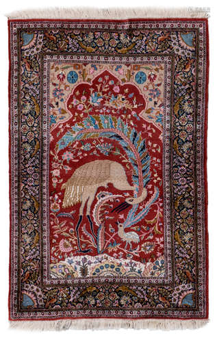 An Oriental rug, floral decorated, with birds, wool and silk on cotton, 113 x 167,5 cm