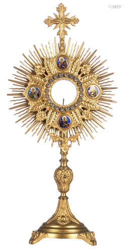 A gilt brass radiate monstrance with champlevé enamelled roundels depicting the Four Evangelists, the body set with strass, late 19thC - early 20thC, H 49,5 cm