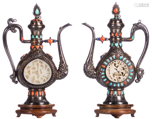 Two silver plated Persian pitchers set with turquoise and red coral, central on both sides a sculpted jade roundel, on a wooden base, H 25 cm - Weight: 2 x 600g (total)