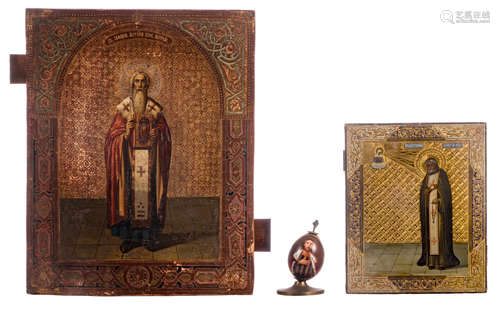 Two Eastern European icons, 19thC, one with a particular nicely wrought and gilt ground, 22 x 27 - 35,5 x 44,5 cm; added a porcelain egg with religious subject, metal mount, 19thC, H 13 cm