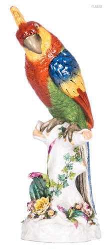 A Saxon polychrome decorated parrot on a branch, with a Meissen mark, H 47 cm