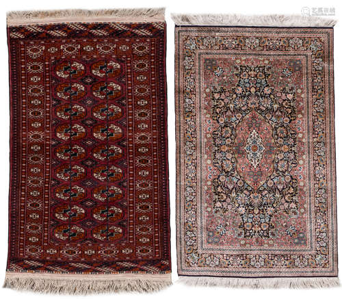 An Oriental silk rug, floral decorated; added an Oriental rug with geometric motifs, wool on cotton, 76 x 122 and 80 x 123 cm