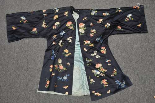 Chinese robe, 19th century. Embroidered decoration of flowers and butterflies on a dark background. (tear at the collar).