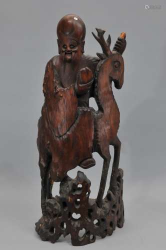 Wood carving. China. 19th century. Figure of Shao Lao and a deer. 36-1/2