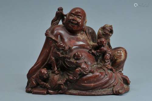 Soapstone carving. China. 19th century. Figure of Milofu with children in red soapstone. 6