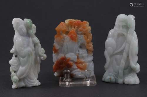 Three Jadeite carvings. China. 20th century. One carved as a mountain landscape with pavilions in lavender and apricot and two lavender and green carvings of a Shao Lao and Kuan Yin. 2-1/4