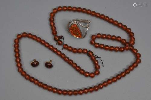 Lot of amber to include a bead necklace, a pair of earrings, and a silver mounted bracelet.