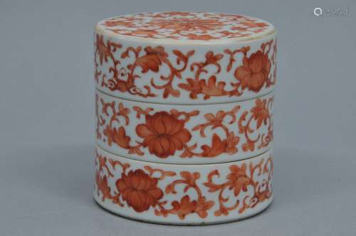 Porcelain box. China. 19th century. Cylindrical stacking form. Iron red decoration of lotus scrolls. 3-1/2