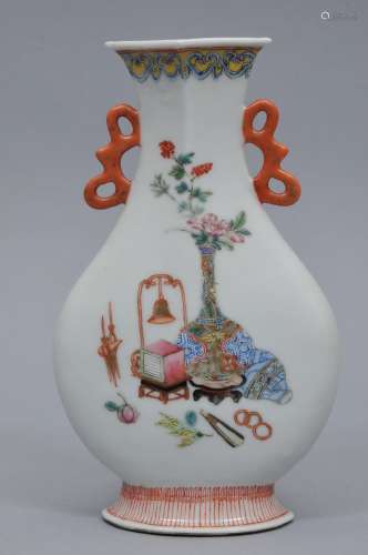 Porcelain vase. China. Late 19th century. Flattened baluster form with a triangular mouth and ribbon handles. Famille Rose decoration of 