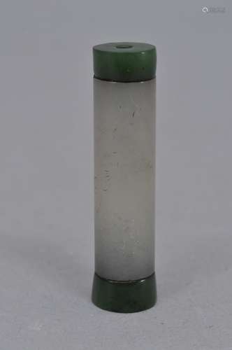 Jade plume holder. China. 19th century. White jade engraved with a prunus branch with an inscription. Green jade ends. 2