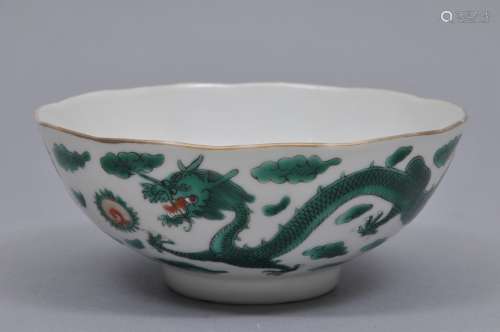 Porcelain bowl. China. 19th century. Scalloped edge. Decoration of dragons and pearls in green with red, white and gilt accents. Tao Kuang mark on the base. 4-3/4