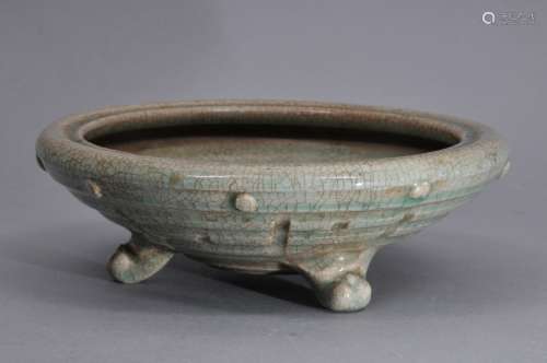 Porcelain censer. China. 19th century. Moulded decoration of trigrams. Three scroll feet. Celadon glaze. 7-3/4