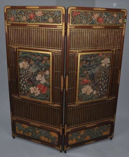 Two panel screen. Japan. Meiji period. (1868-1912). Surface carved wood with peacocks and flowers Gilt engraved copper mounts. 57