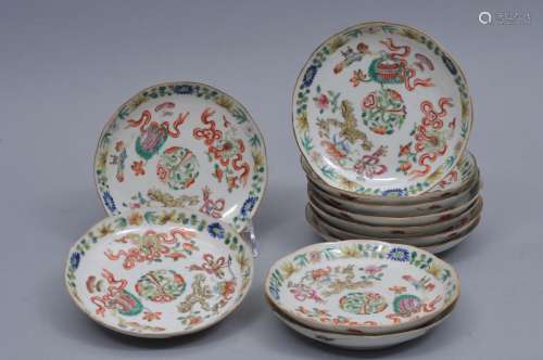 Lot of 11 porcelain saucer dishes, China. Foliate edge. Famille rose decoration of auspicious emblems. 5 1/2